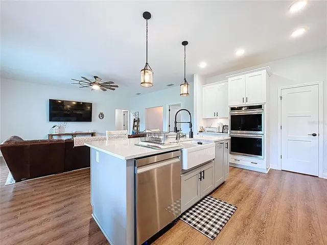 a kitchen with stainless steel appliances white cabinets and stove