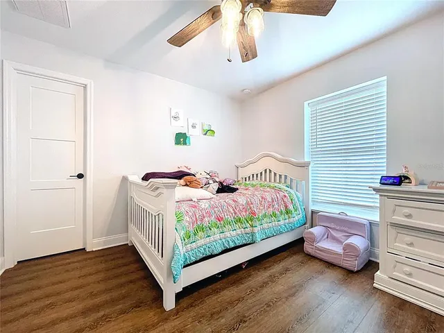 a bedroom with bed and a chandelier