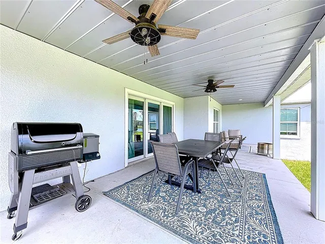 a outdoor space with patio the couches and a dining table with garden view