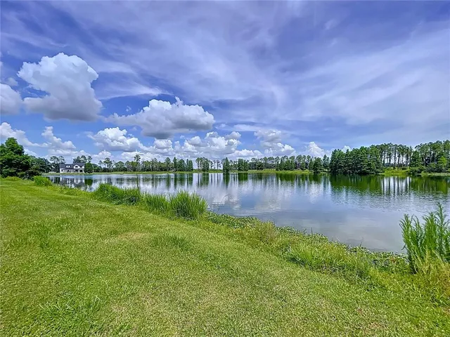an aerial view of a house with pool and a yard