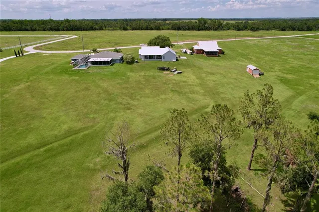 a aerial view of a house with a yard and a balcony