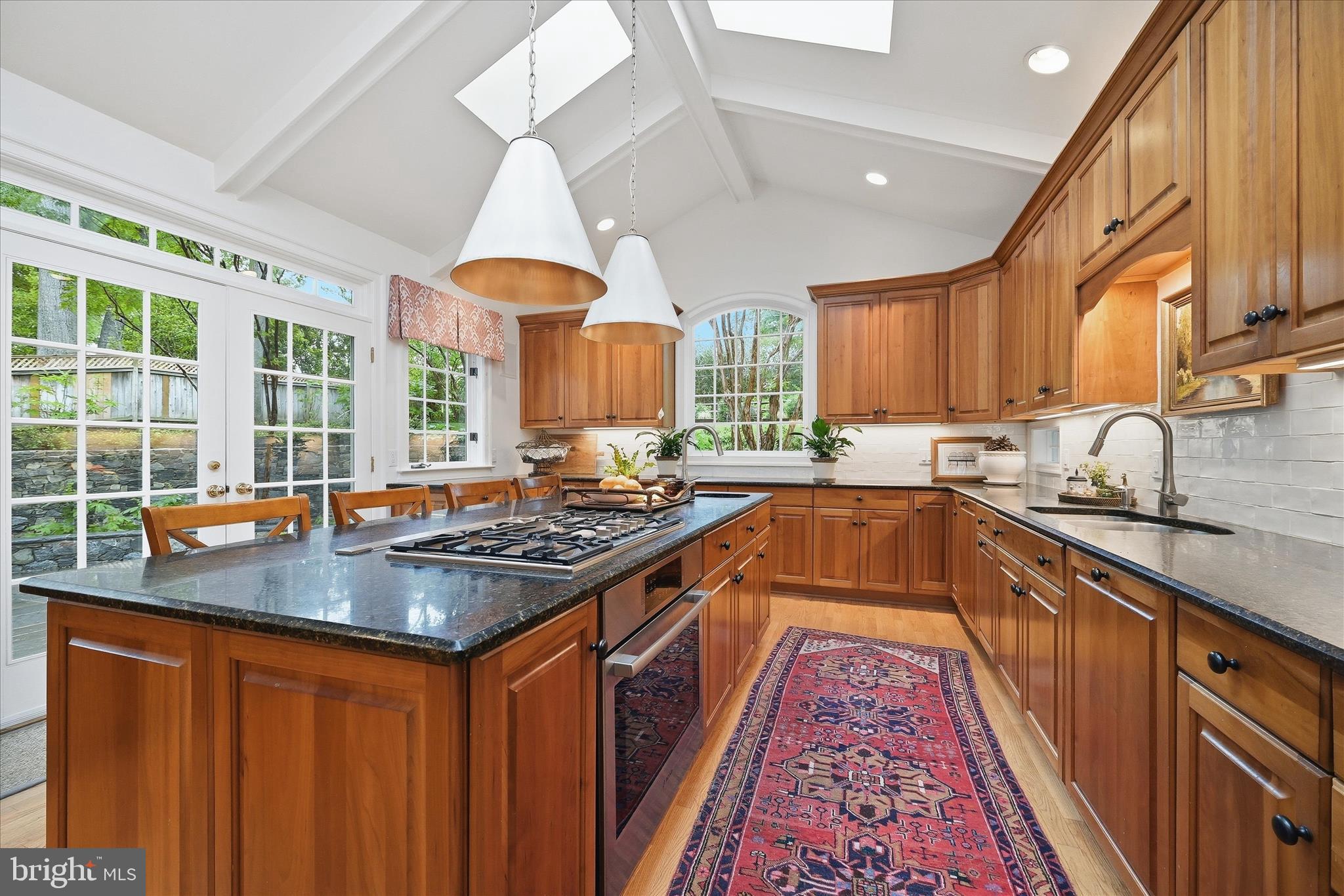 3824 Military Road Arlington, VA 22207 - Photo 10 of 54 a kitchen with stainless steel appliances granite countertop a stove a sink dishwasher and a microwave oven with large trees
