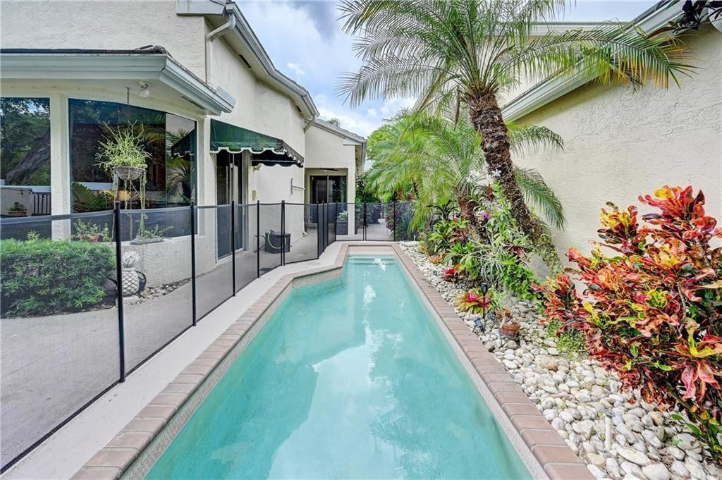 8171 Hampton Wood Drive Boca Raton, FL 33433 - Photo 26 of 56 a view of a backyard with plants