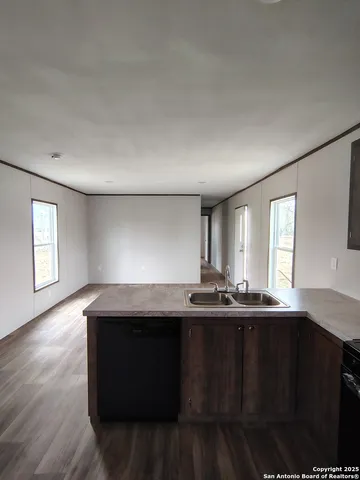 a kitchen with stainless steel appliances granite countertop a refrigerator a sink and a stove