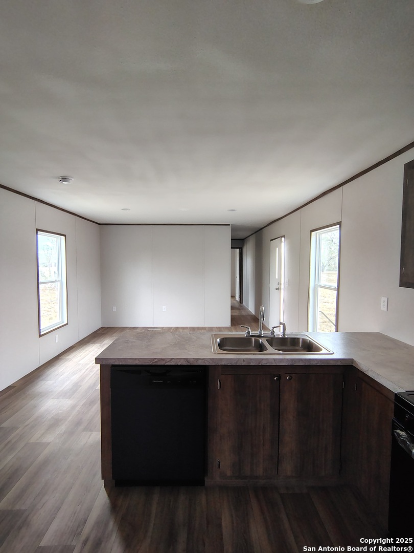 152 County Road 2664 Devine, TX 78016 - Photo 5 of 17 a kitchen with a sink and wooden floor