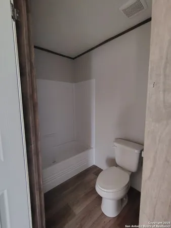 a bathroom with a toilet a sink and a mirror