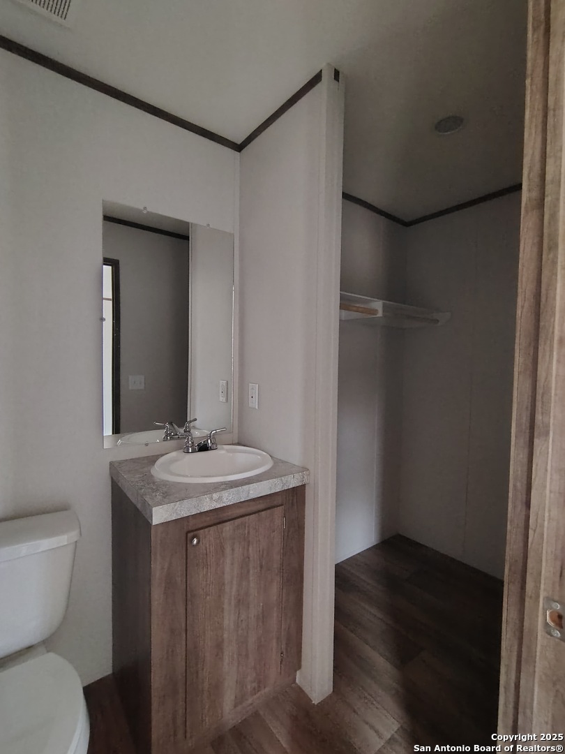 152 County Road 2664 Devine, TX 78016 - Photo 10 of 17 a bathroom with a sink and a mirror
