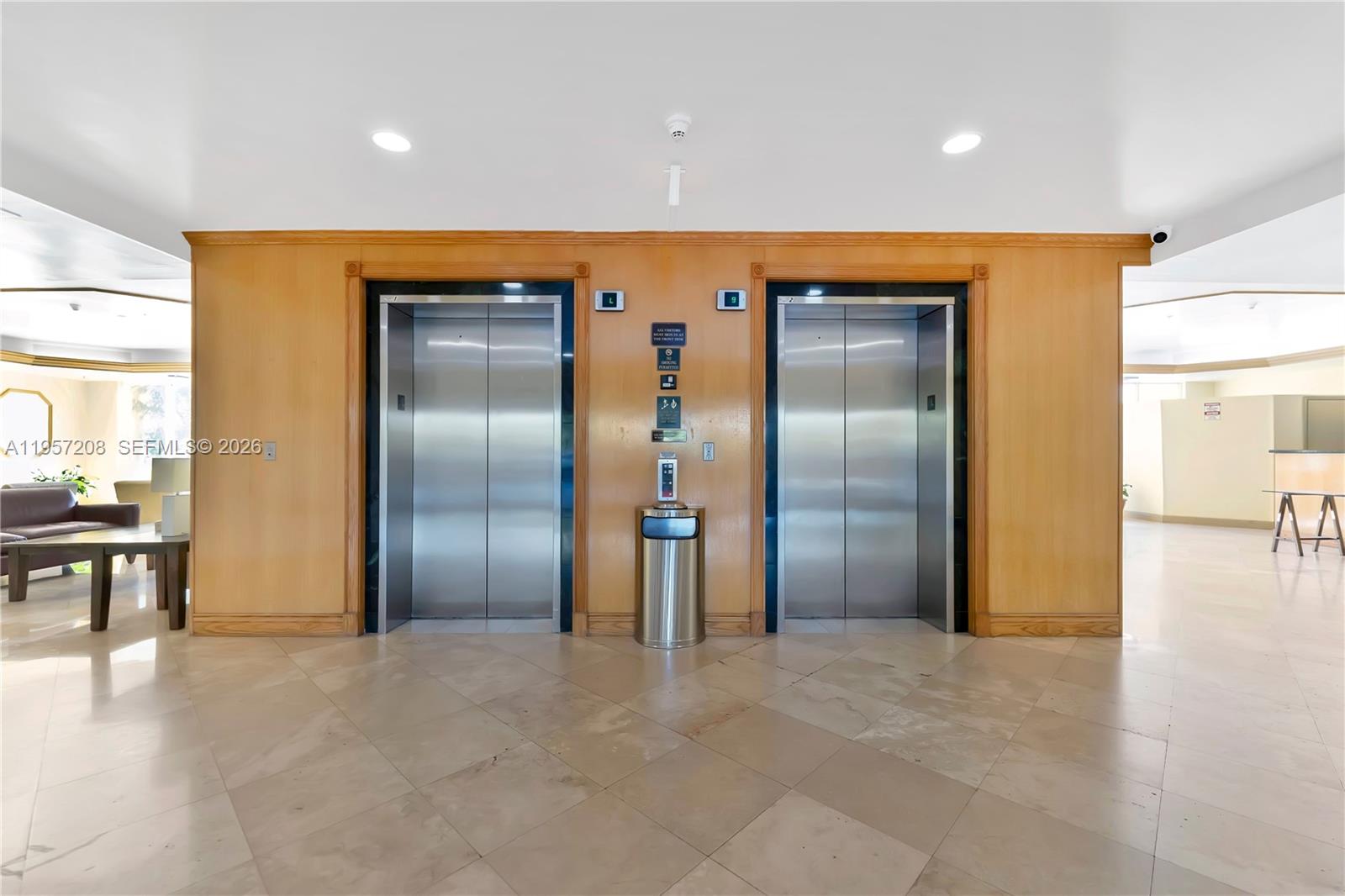 3500 Coral Way, Unit 710 Miami, FL 33145 - Photo 12 of 43 Elegant building lobby featuring dual elevator access and classic accents.