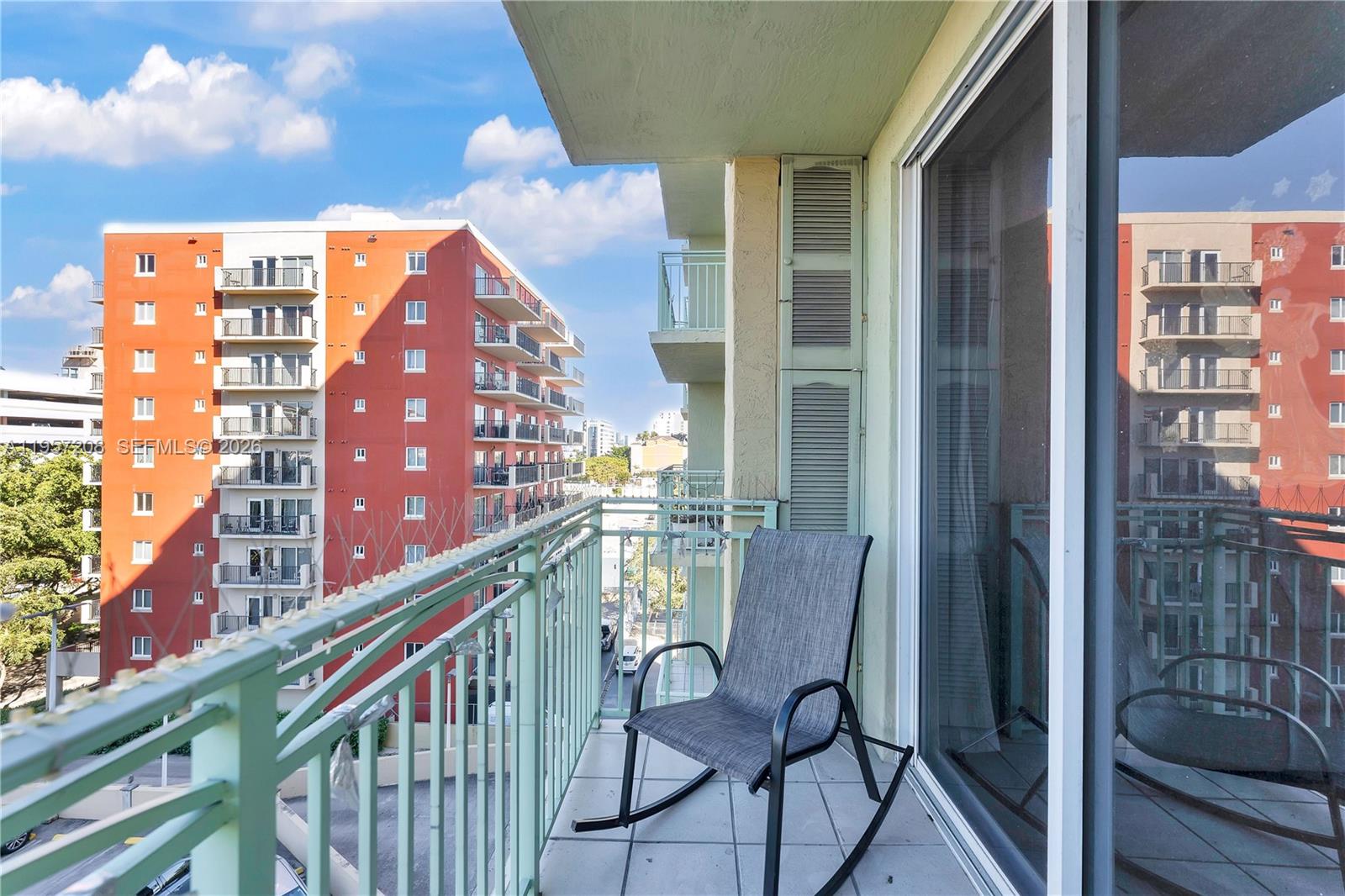 3500 Coral Way, Unit 710 Miami, FL 33145 - Photo 2 of 39 Enjoy fresh air and city views from this private, sunny balcony. This tiled outdoor space offers the perfect urban retreat for morning coffee or evening relaxation.
