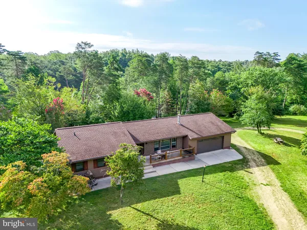 an aerial view of a house with swimming pool garden and patio