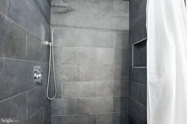 a view of a room with furniture and wooden floor