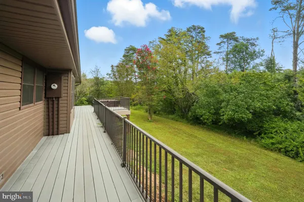 an aerial view of residential house with outdoor space and trees all around