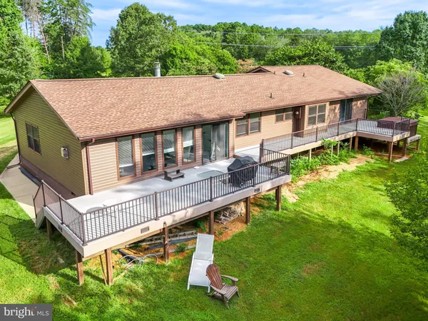 a aerial view of a house with pool garden view and mountain view