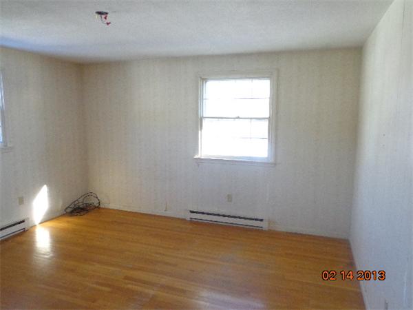 24 Juniper Lane Rutland, MA 01543 - Photo 8 of 11 an empty room with wooden floor and windows
