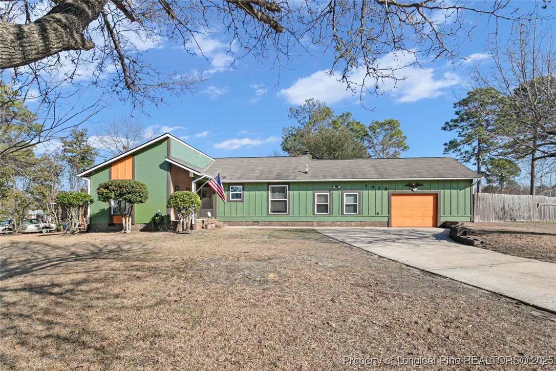 a front view of a house with a yard and a garage