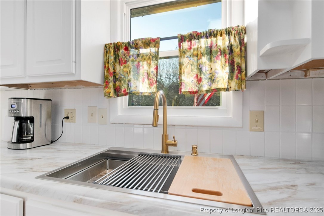 5978 Brookcliff Road Fayetteville, NC 28304 - Photo 12 of 38 a kitchen with a sink and cabinets