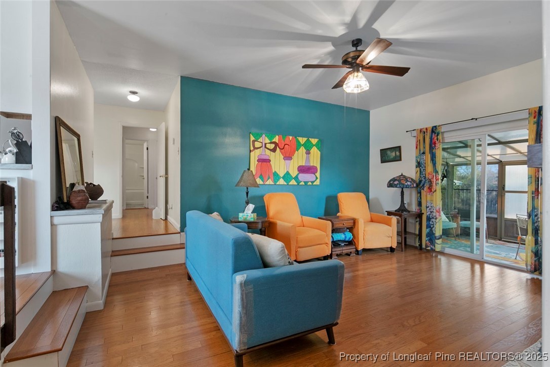 5978 Brookcliff Road Fayetteville, NC 28304 - Photo 15 of 38 a living room with furniture and a chandelier