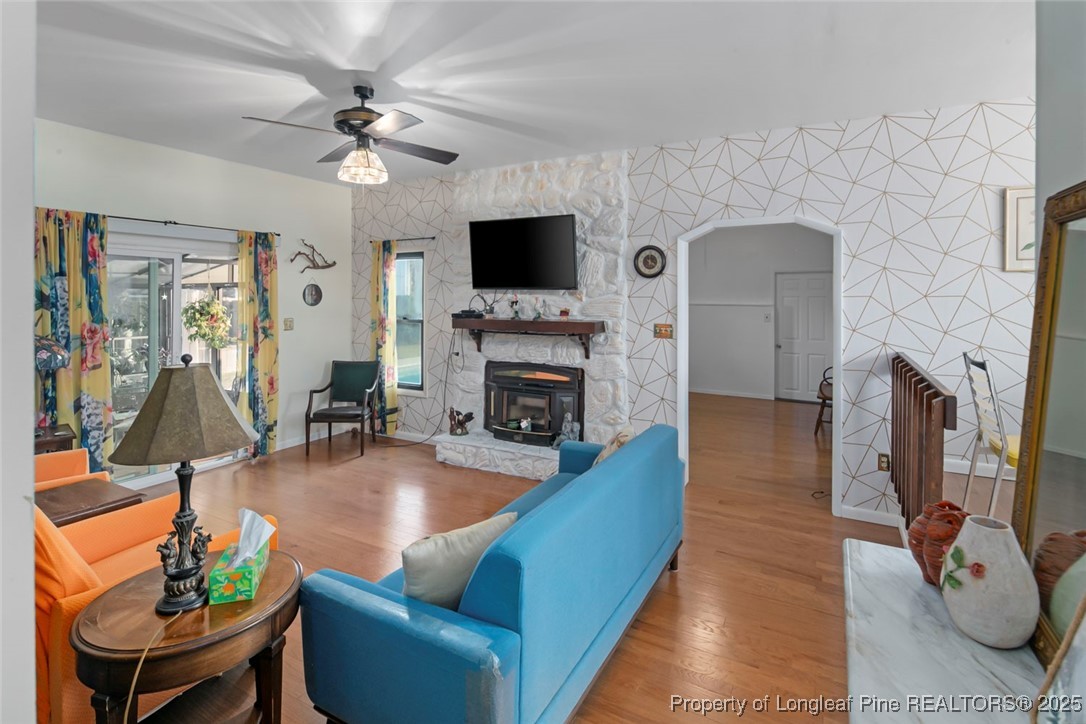 5978 Brookcliff Road Fayetteville, NC 28304 - Photo 16 of 38 a living room with furniture a flat screen tv and a fireplace