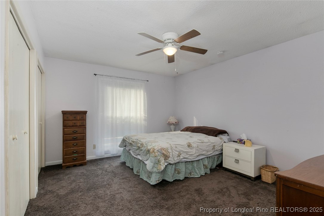 5978 Brookcliff Road Fayetteville, NC 28304 - Photo 24 of 38 a bedroom with a bed and a chandelier