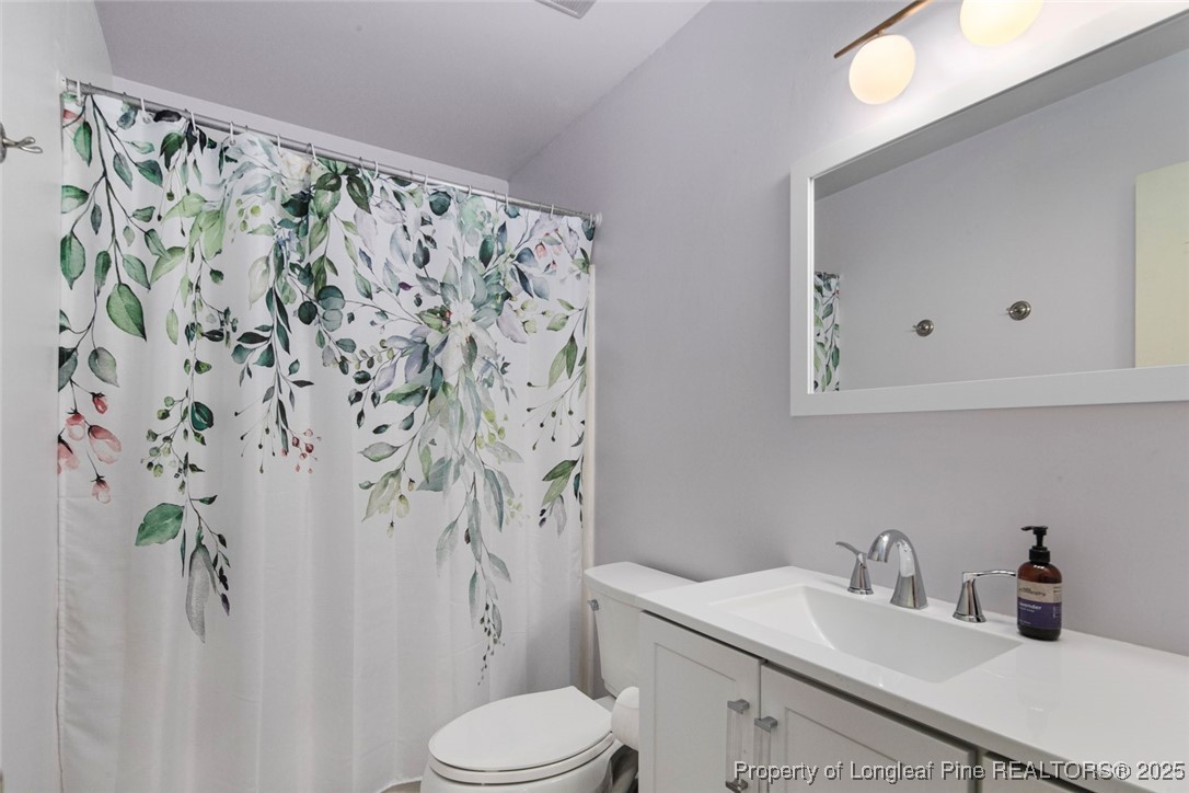 5978 Brookcliff Road Fayetteville, NC 28304 - Photo 25 of 38 a bathroom with a sink toilet and shower