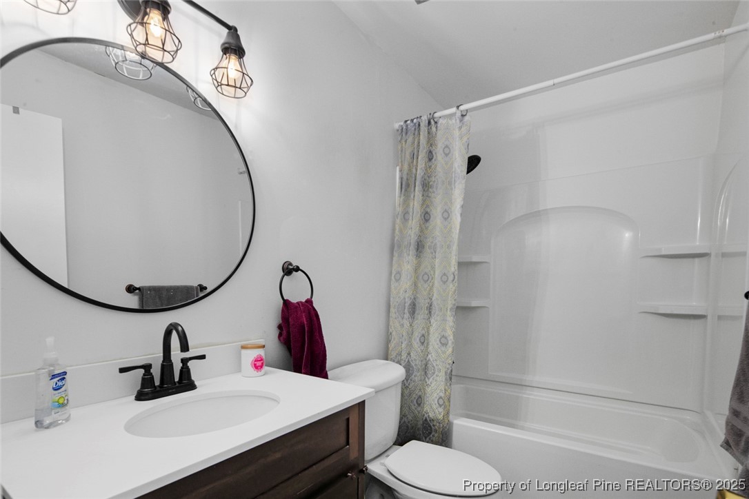 5978 Brookcliff Road Fayetteville, NC 28304 - Photo 30 of 38 a bathroom with a sink toilet and shower