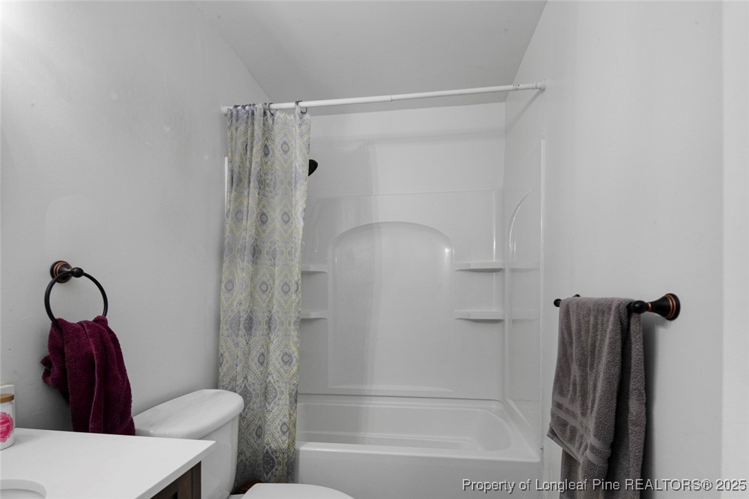 5978 Brookcliff Road Fayetteville, NC 28304 - Photo 31 of 38 a bathroom with a shower and a toilet