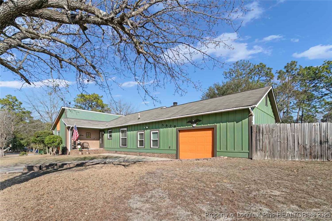 5978 Brookcliff Road Fayetteville, NC 28304 - Photo 34 of 38 a view of an house with backyard space and a tree