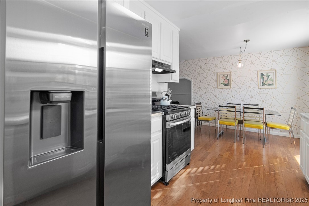 5978 Brookcliff Road Fayetteville, NC 28304 - Photo 10 of 38 a kitchen with stainless steel appliances granite countertop a refrigerator and a stove