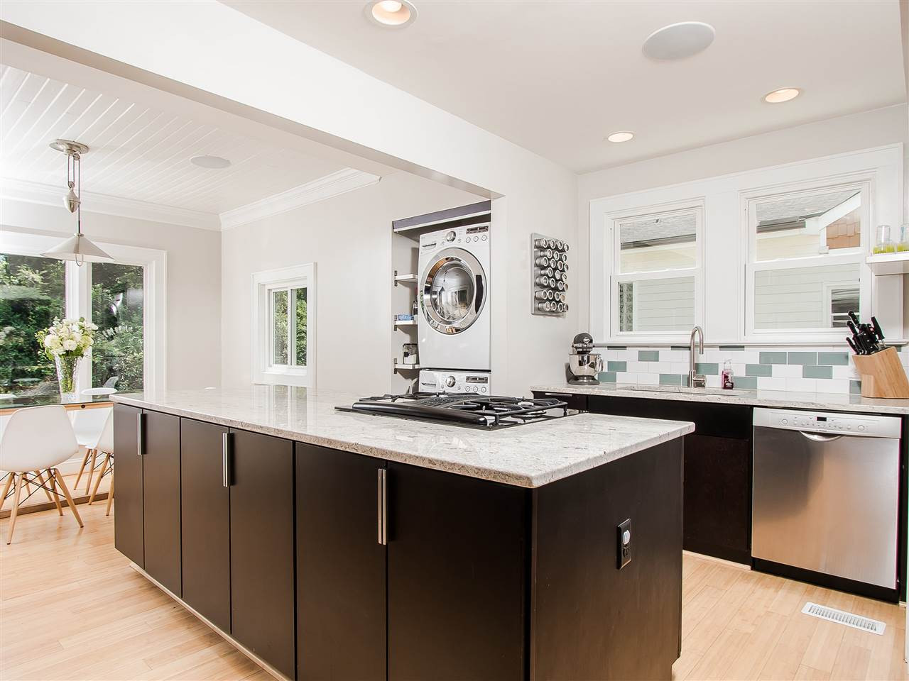 1634 Bickett Boulevard Raleigh, NC 27608 - Photo 9 of 25 Gorgeous center island atop the finest contemporary cabinetry. Convenient laundry area with LG washer and dryer that convey. Kitchen/Laundry