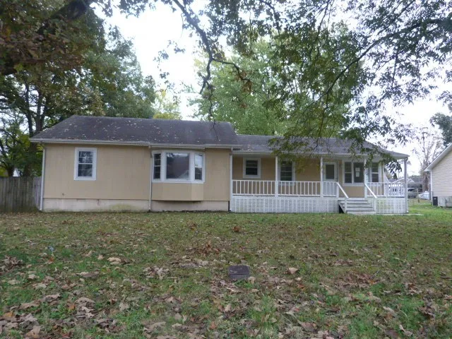 a house that has a tree in front of a house