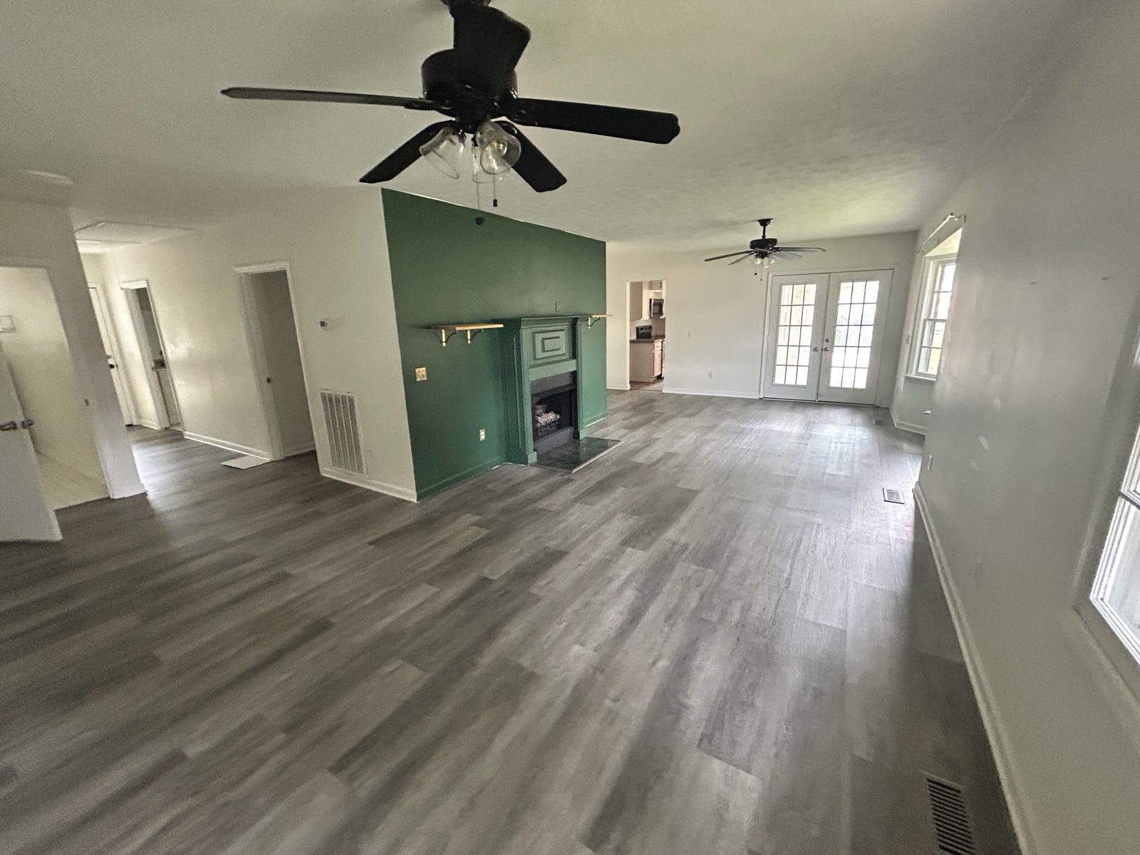 303 Willow Street Manchester, TN 37355 - Photo 3 of 15 a view of a livingroom with wooden floor and a ceiling fan