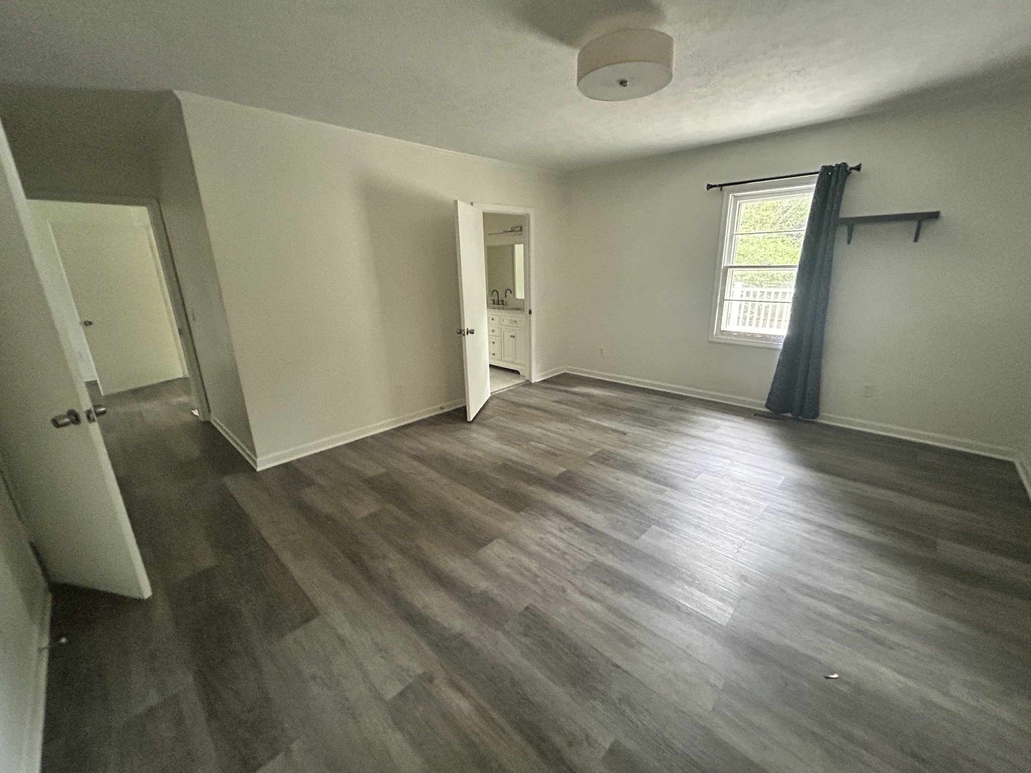 303 Willow Street Manchester, TN 37355 - Photo 5 of 15 a view of empty room with wooden floor and fan