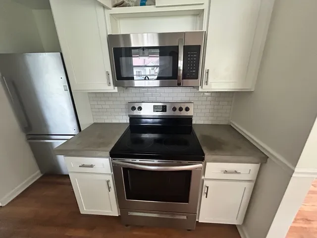 a stove top oven sitting inside of a kitchen