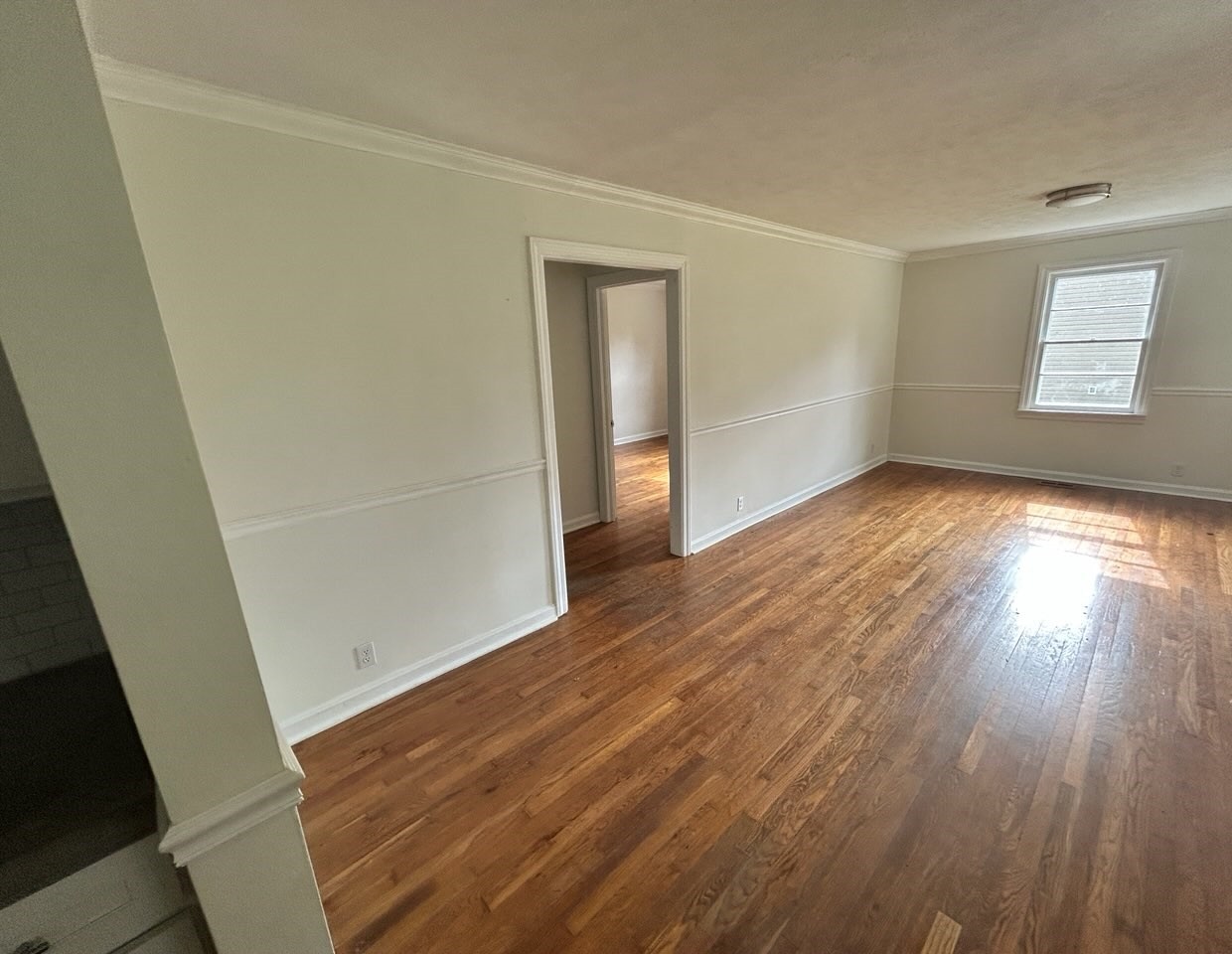 303 Willow Street Manchester, TN 37355 - Photo 10 of 15 an empty room with wooden floor and windows