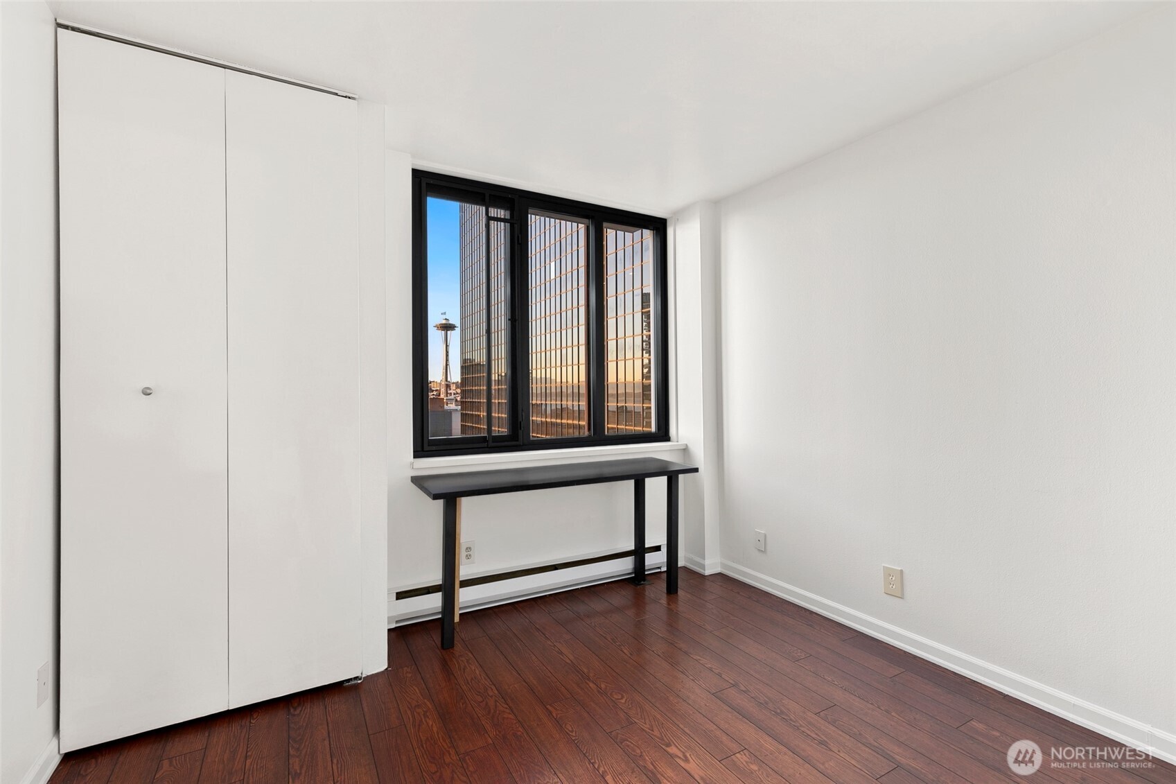 2100 3rd Avenue, Unit 1503 Seattle, WA 98121 - Photo 12 of 40 a view of an empty room with wooden floor and a window