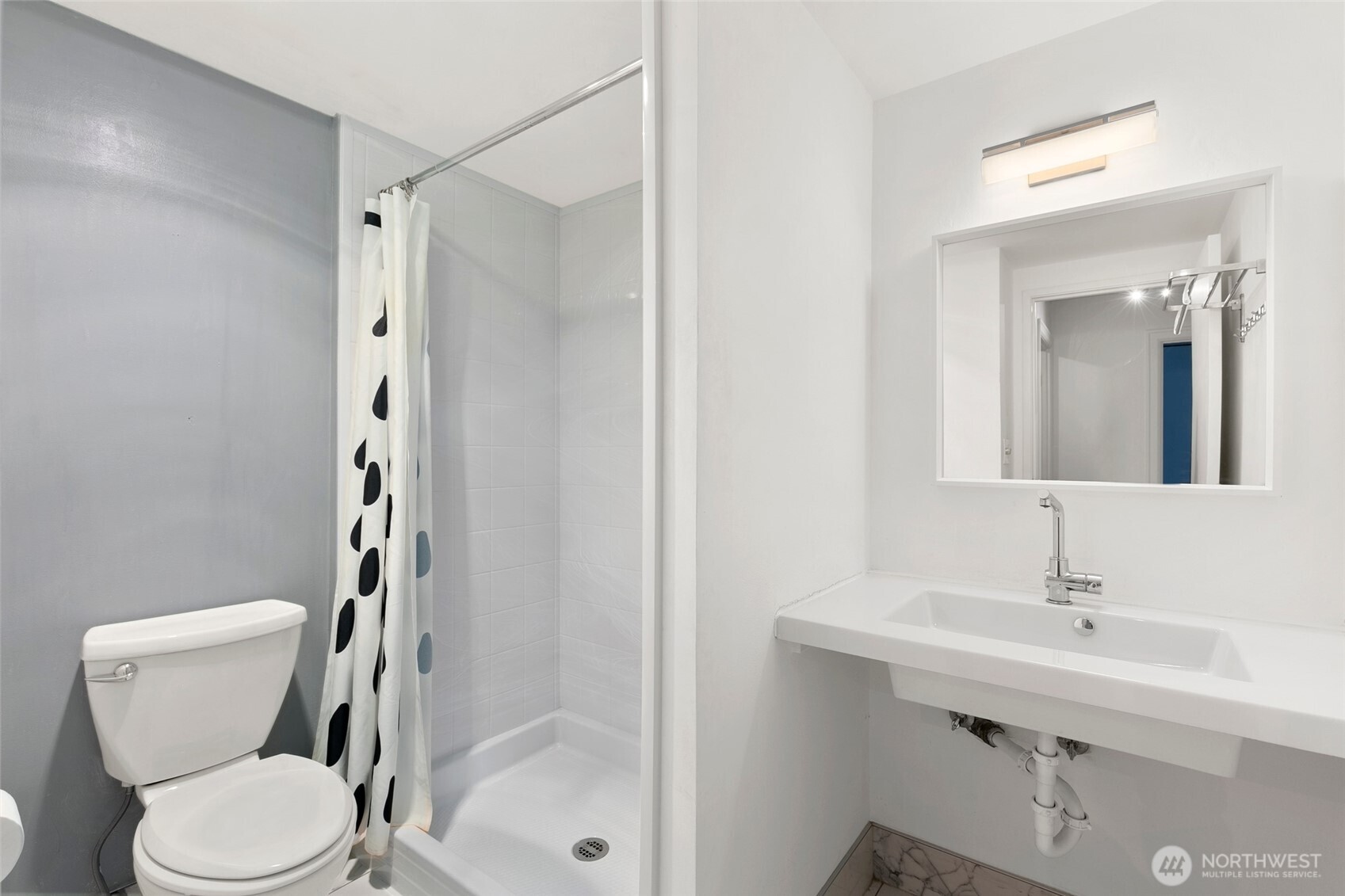 2100 3rd Avenue, Unit 1503 Seattle, WA 98121 - Photo 13 of 40 a bathroom with a toilet sink shower and mirror