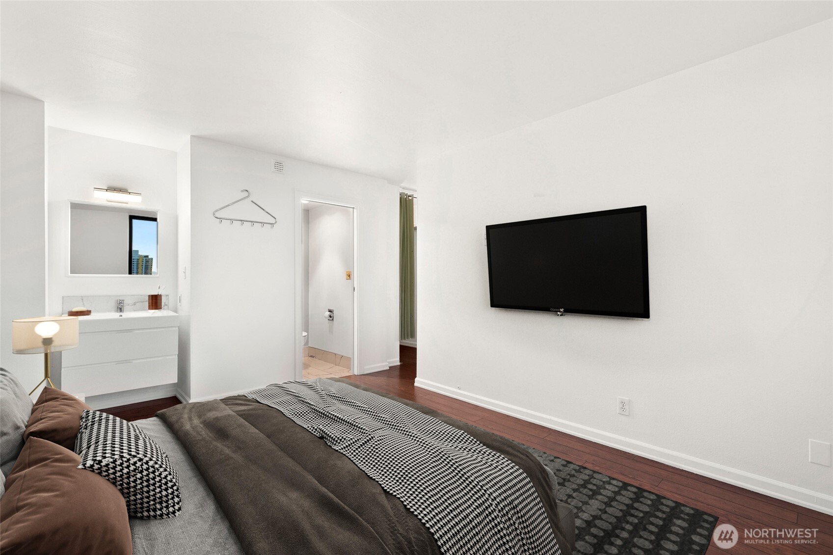 2100 3rd Avenue, Unit 1503 Seattle, WA 98121 - Photo 15 of 40 a bedroom with a bed and a flat screen tv