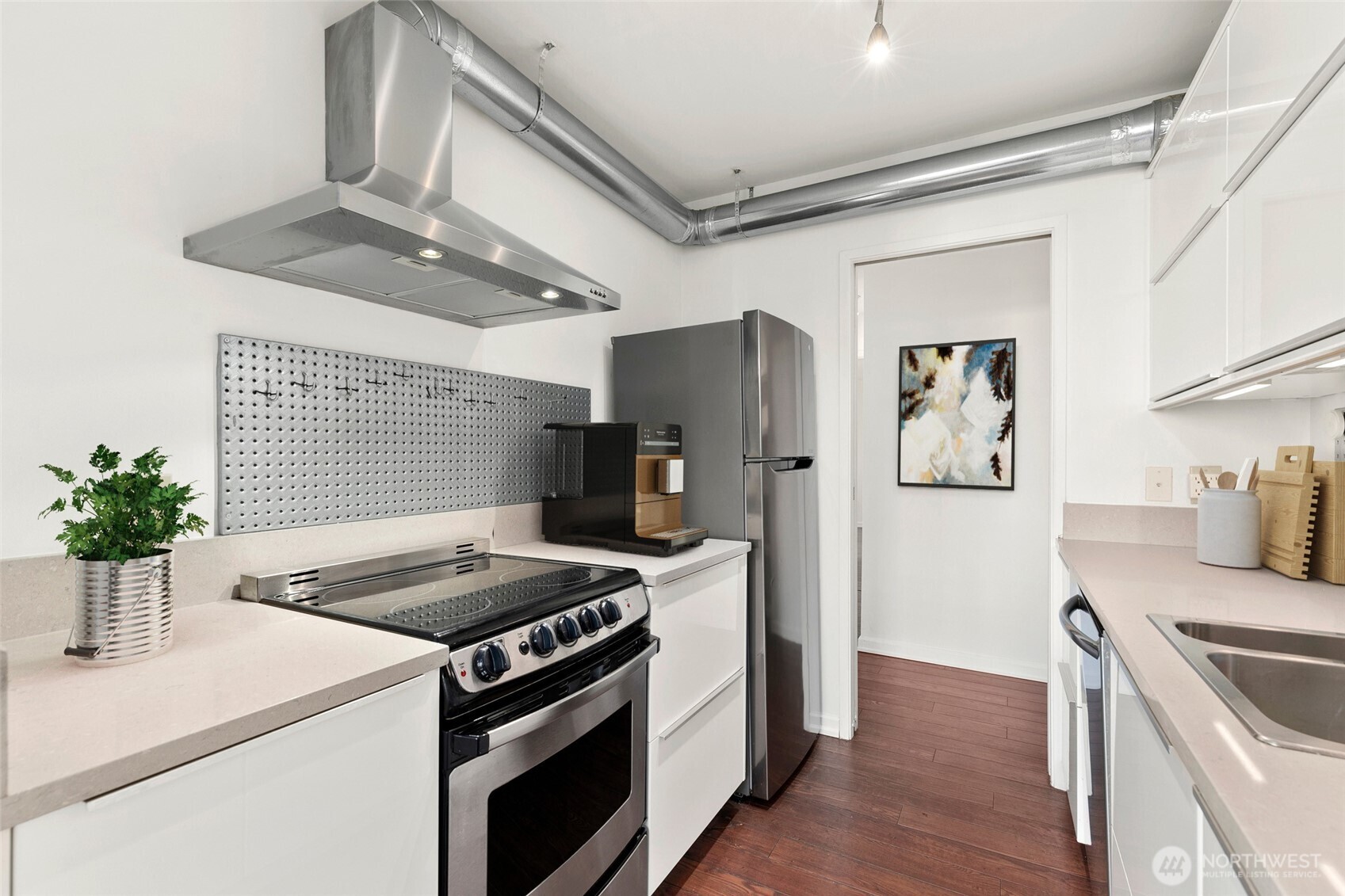 2100 3rd Avenue, Unit 1503 Seattle, WA 98121 - Photo 10 of 40 a kitchen with stainless steel appliances kitchen island a stove a refrigerator and a sink