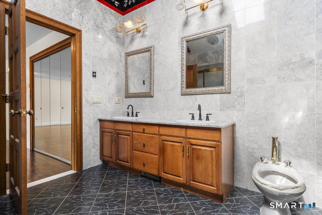 49 Partridge Lane Middletown, CT 06457 - Photo 19 of 39 a spacious bathroom with a double vanity sink double mirror and toilet
