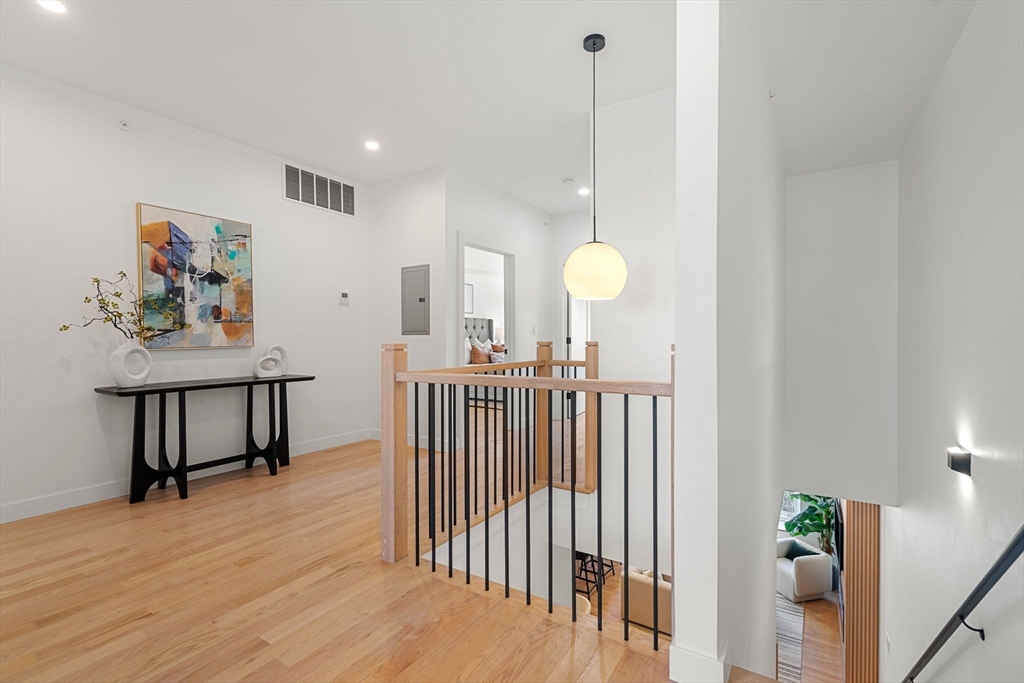 122 Washington Street, Unit 22 Weymouth, MA 02188 - Photo 15 of 37 a view of a hallway with paintings on the wall