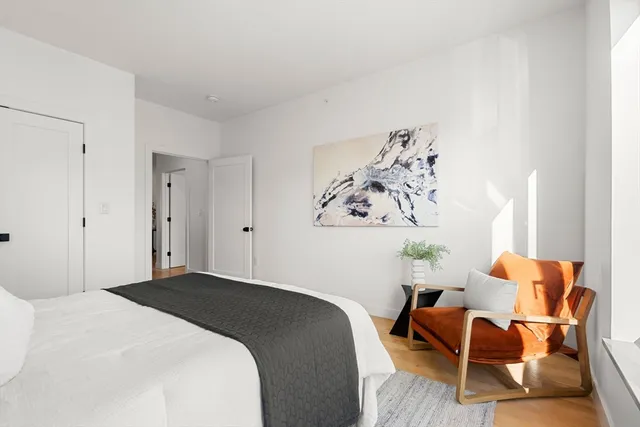 a bedroom with a bed and chair