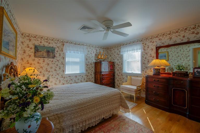 126 River Ridge Road Marstons Mills, MA 02648 - Photo 20 of 33 a bedroom with a bed table flowerpot and window