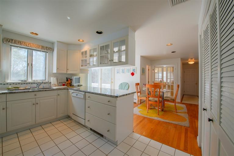 126 River Ridge Road Marstons Mills, MA 02648 - Photo 9 of 33 a kitchen with sink cabinets and dining table chair