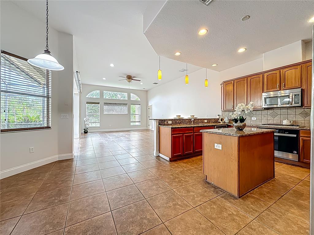 20626 Longleaf Pine Avenue Tampa, FL 33647 - Photo 13 of 86 a kitchen with stainless steel appliances granite countertop a stove a sink and a refrigerator
