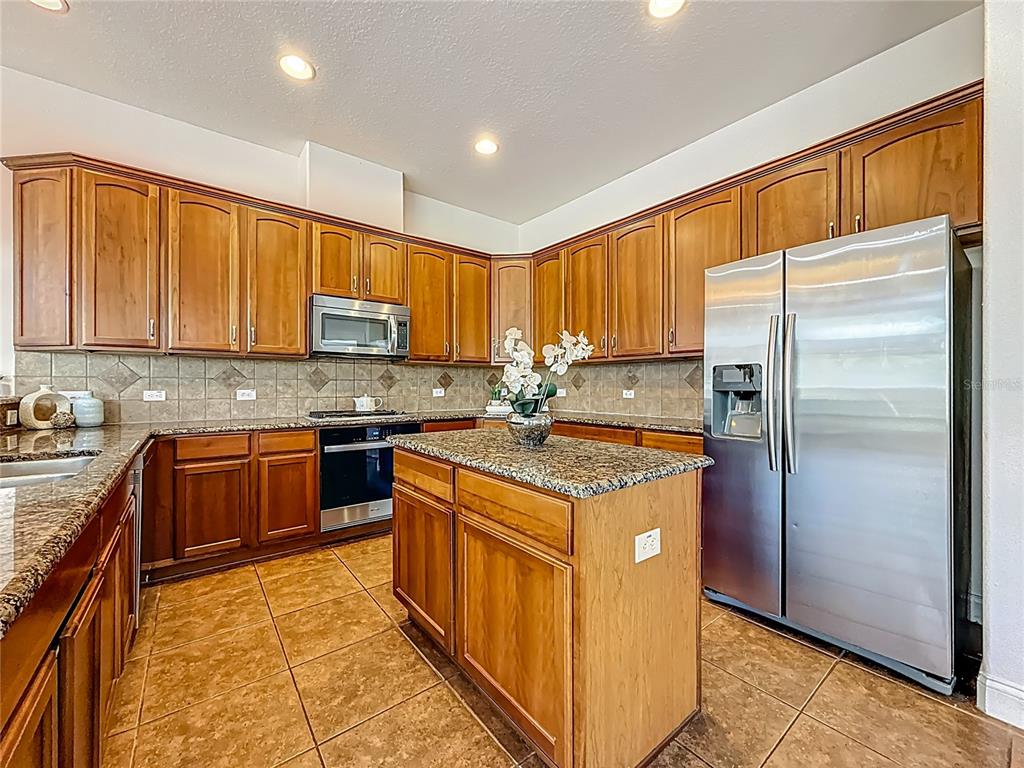 20626 Longleaf Pine Avenue Tampa, FL 33647 - Photo 14 of 86 a kitchen with stainless steel appliances granite countertop a stove a refrigerator and a sink