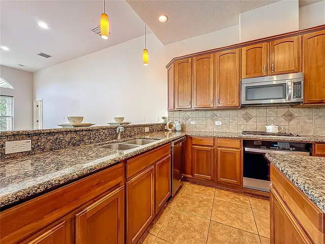 a view of a kitchen with a sink and a stove