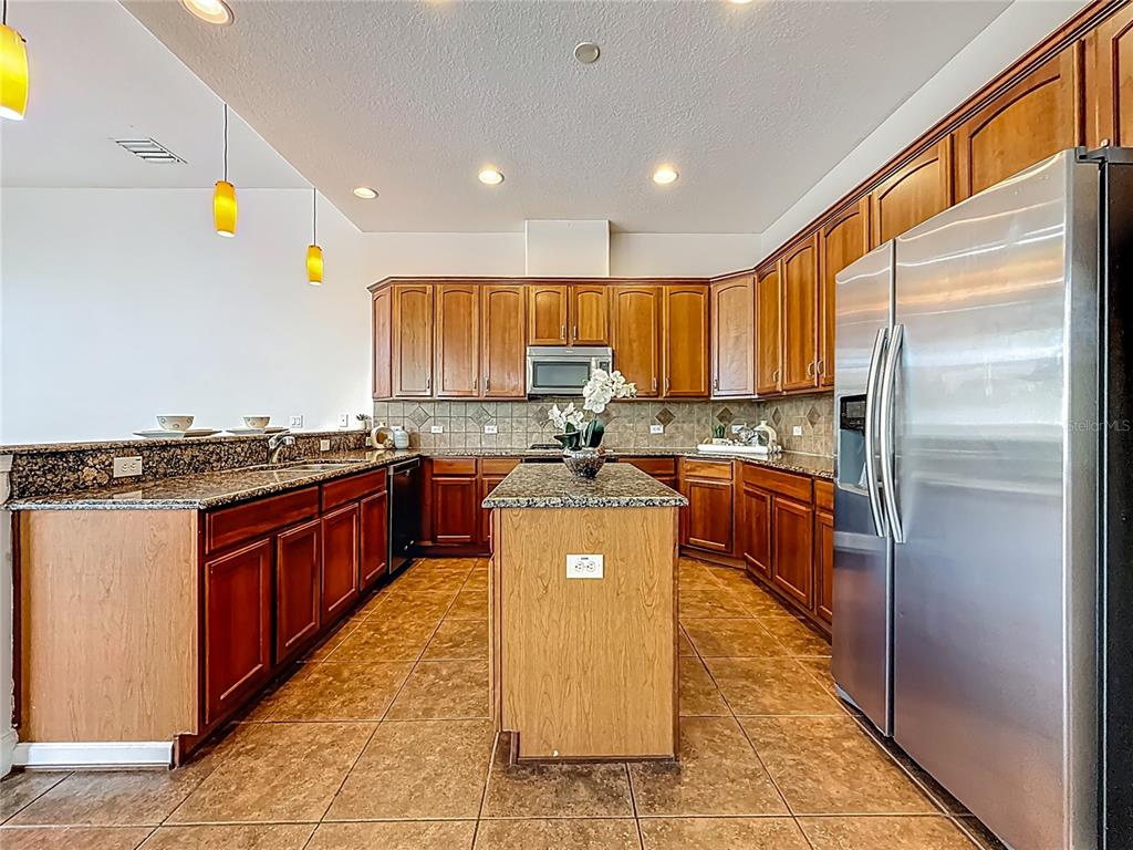 20626 Longleaf Pine Avenue Tampa, FL 33647 - Photo 16 of 86 a kitchen with stainless steel appliances granite countertop a refrigerator a stove and a sink