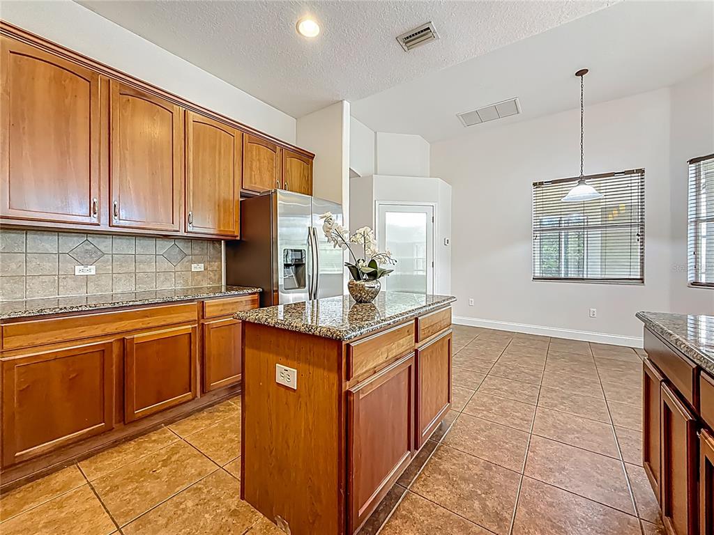 20626 Longleaf Pine Avenue Tampa, FL 33647 - Photo 18 of 86 a kitchen with stainless steel appliances granite countertop a sink stove and refrigerator