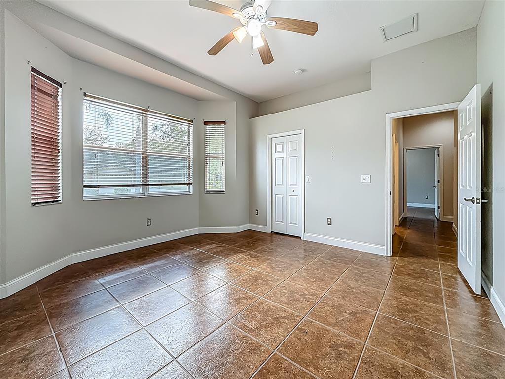 20626 Longleaf Pine Avenue Tampa, FL 33647 - Photo 55 of 86 a view of an empty room with window and chandelier fan