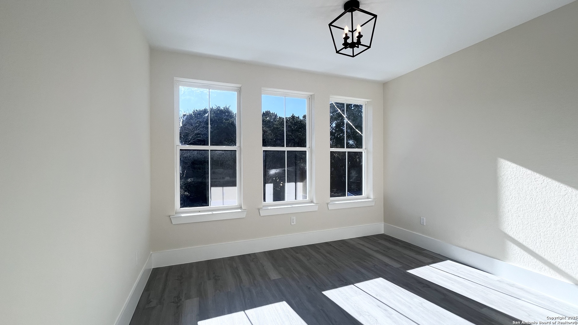 477 Scenic Drive Bandera, TX 78003 - Photo 14 of 22 a view of an empty room with wooden floor and a window